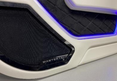 A close up of a speaker on the side of a car.