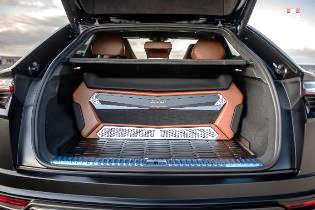 The trunk of a car with a speaker in it.