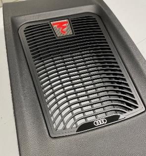 A close up of a speaker on the side of a car.