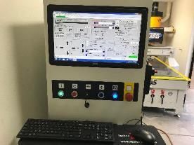 A computer monitor is sitting on top of a desk next to a keyboard and mouse.