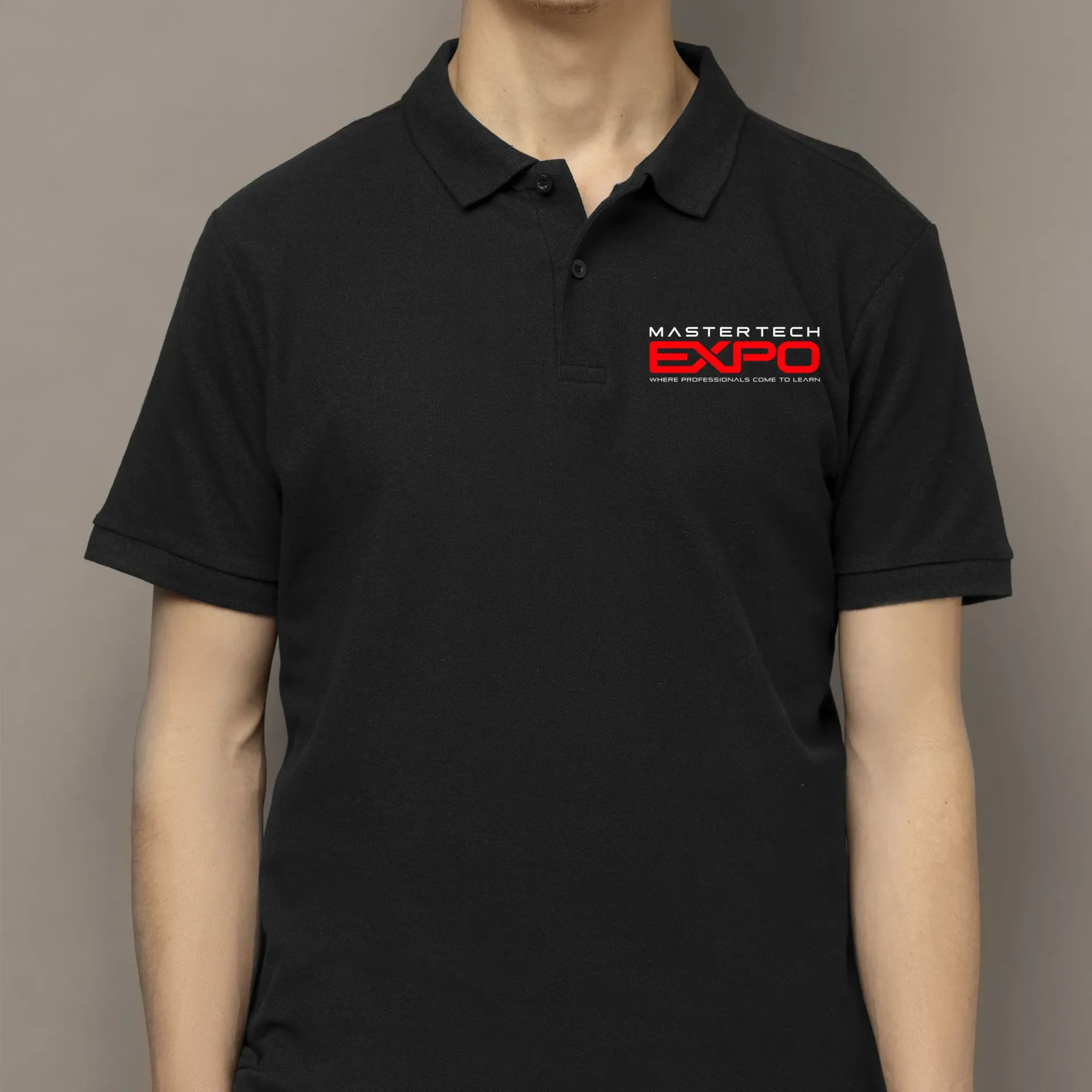 A man wearing a black polo shirt that says expo