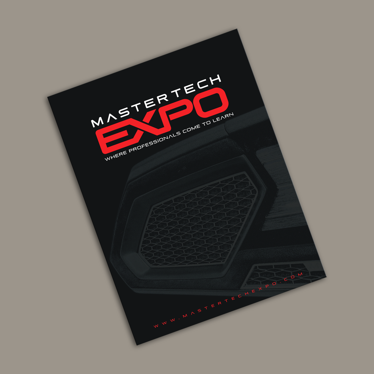 A mastertech expo brochure is laying on a table