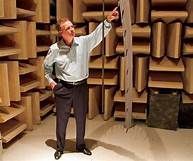 A man is standing in a very loud room.