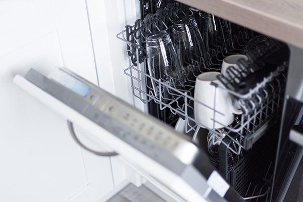 Open Dishwasher with Clean Glasses and Dishes — Cape Cod, MA — Cape Appliance Repairs