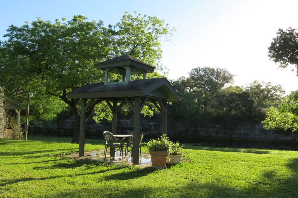 A gazebo in the middle of a lush green field