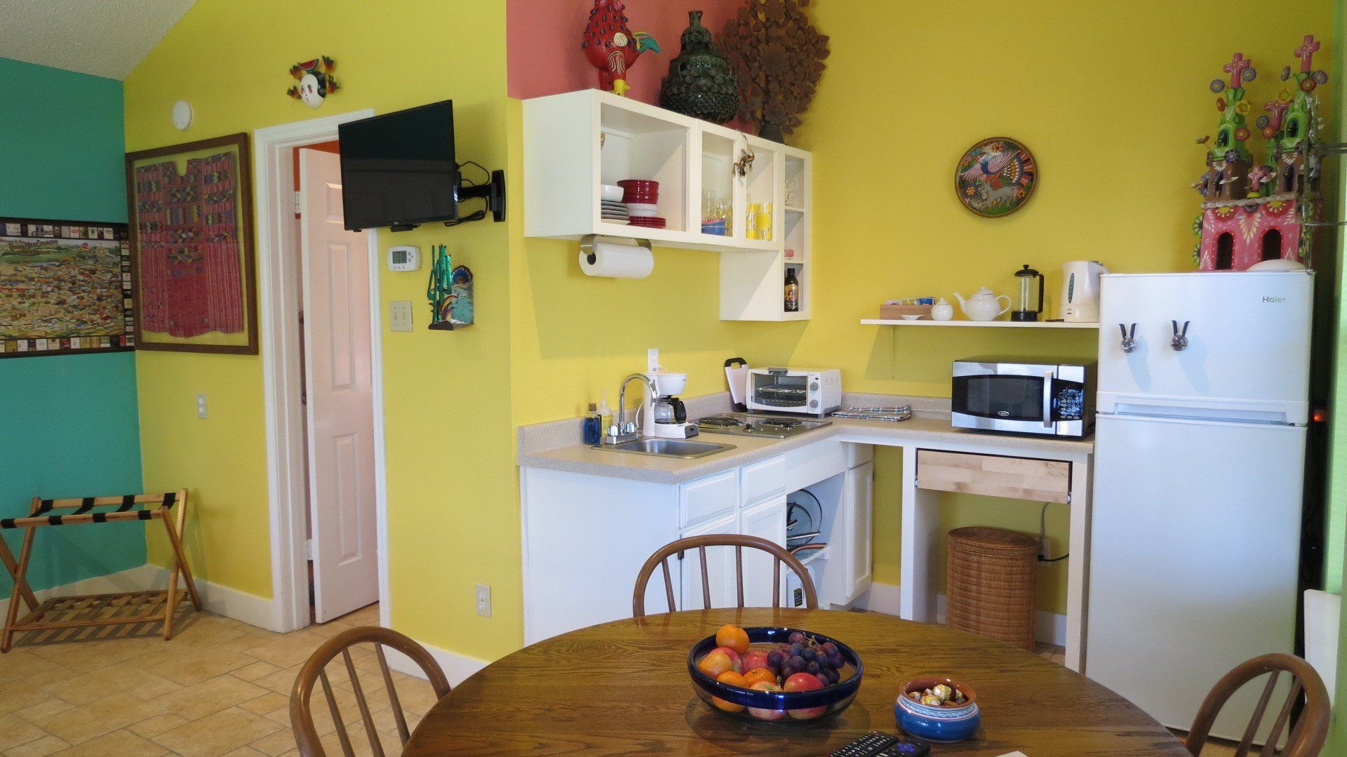 A kitchen with a table and chairs and a refrigerator