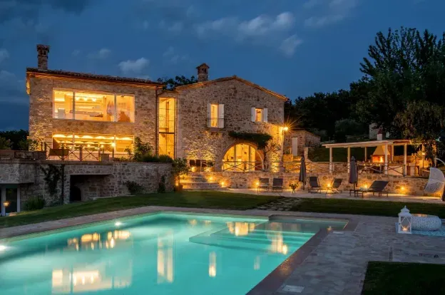 View from an airplane window of a cityscape at sunrise, golden light illuminating skyscrapers.