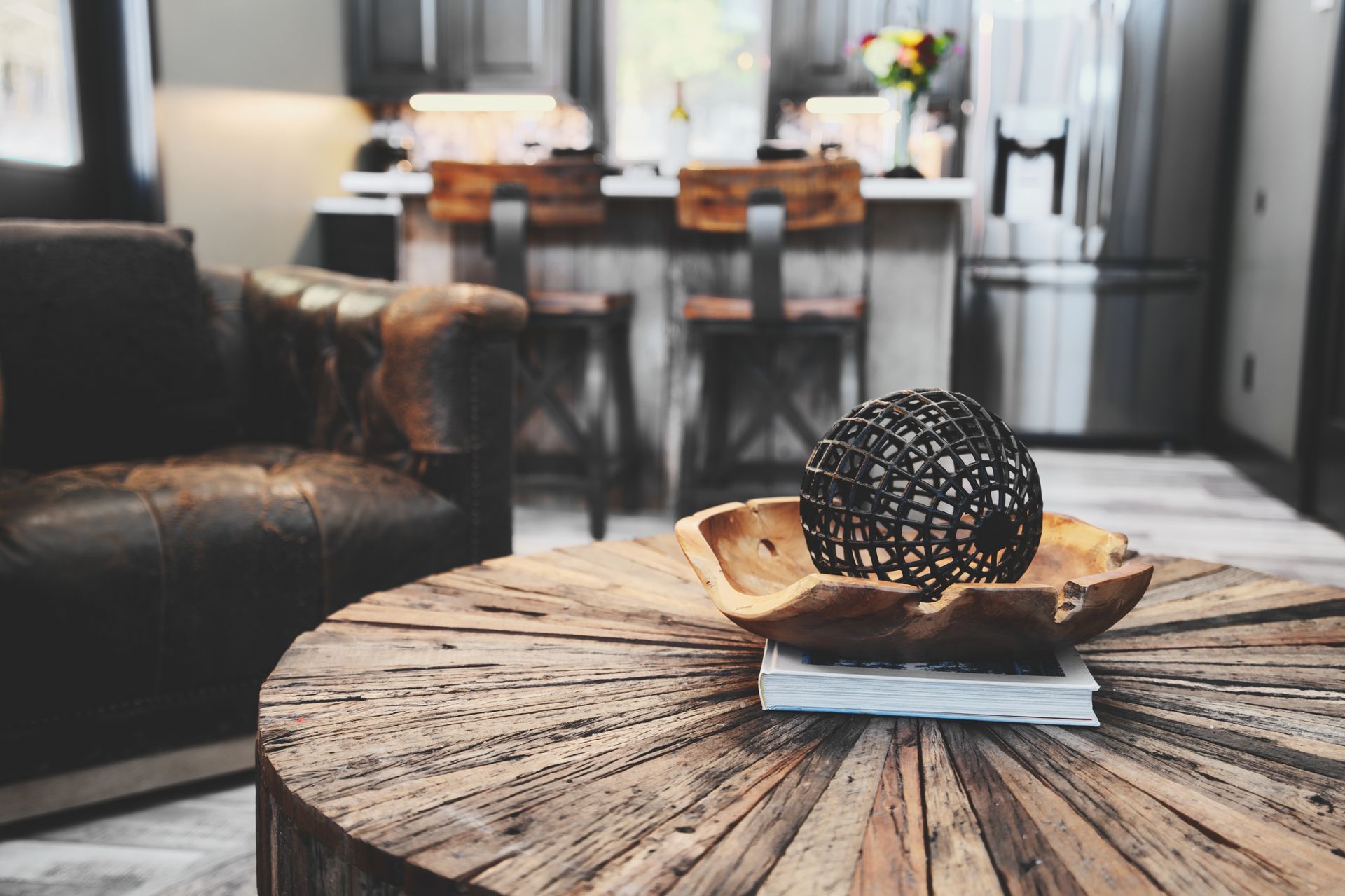 A wooden coffee table with a bowl on top of it in a living room.