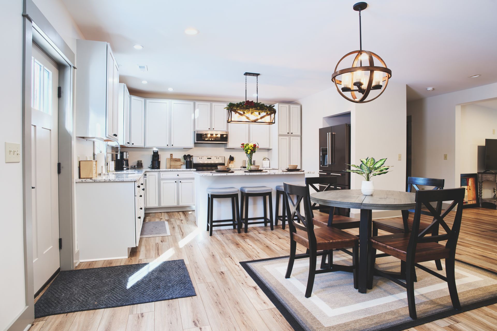 A kitchen and dining room in a house with a table and chairs.