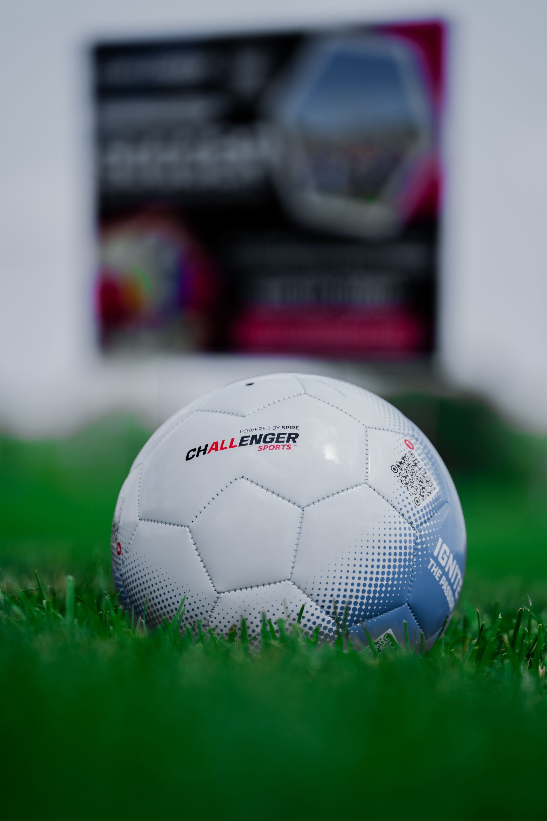 A soccer ball is sitting on top of a lush green field.