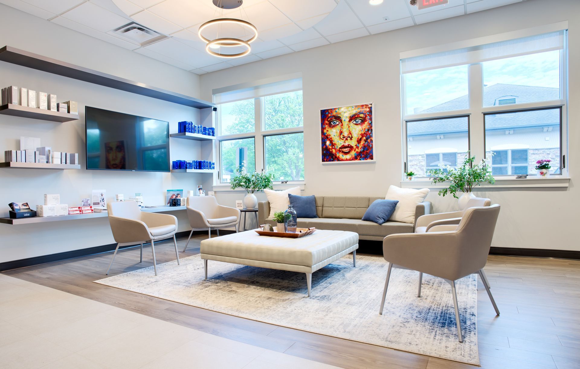 A living room with a couch , chairs , coffee table and television.