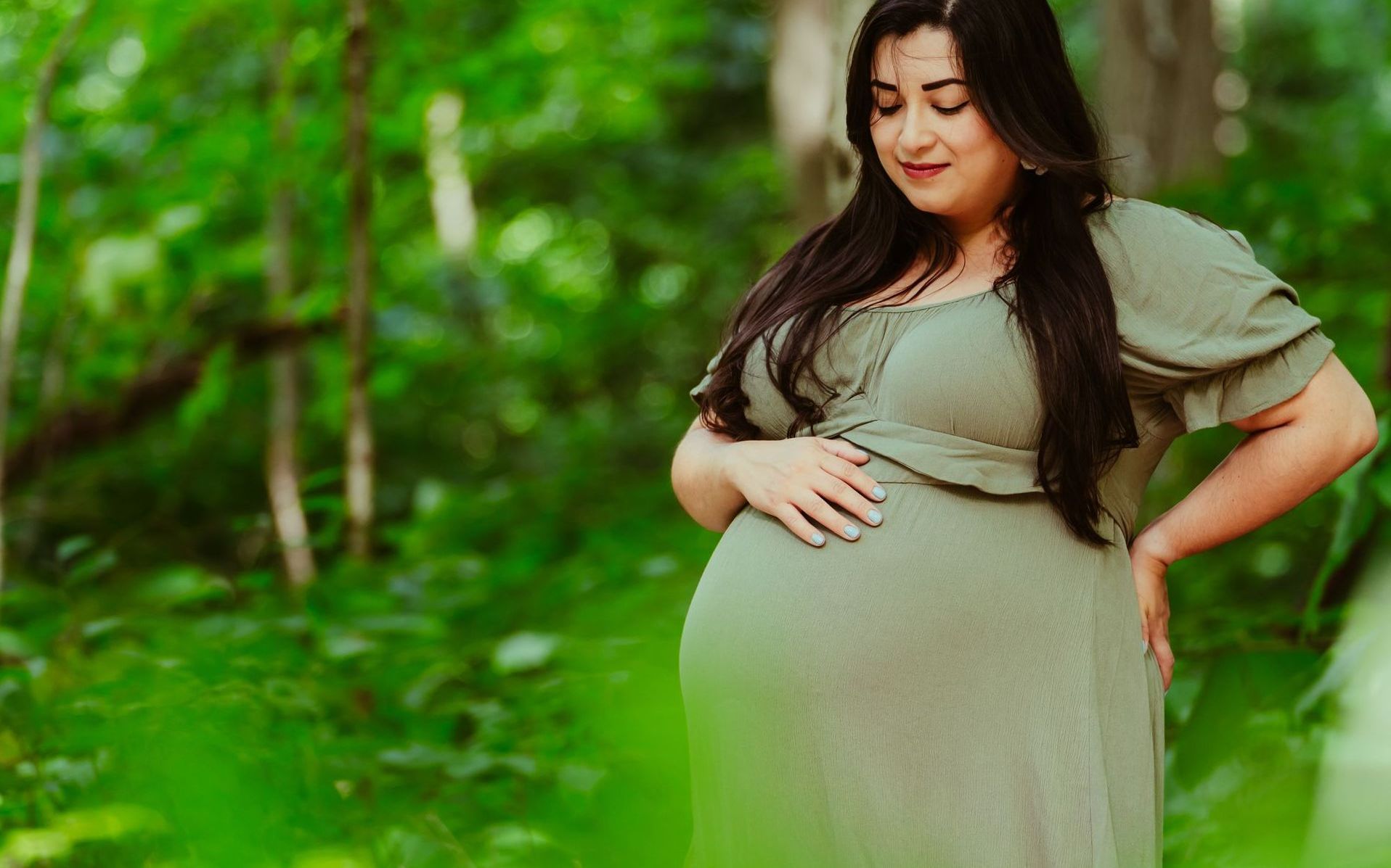a man and a woman are holding a pair of baby shoes in their hands .
