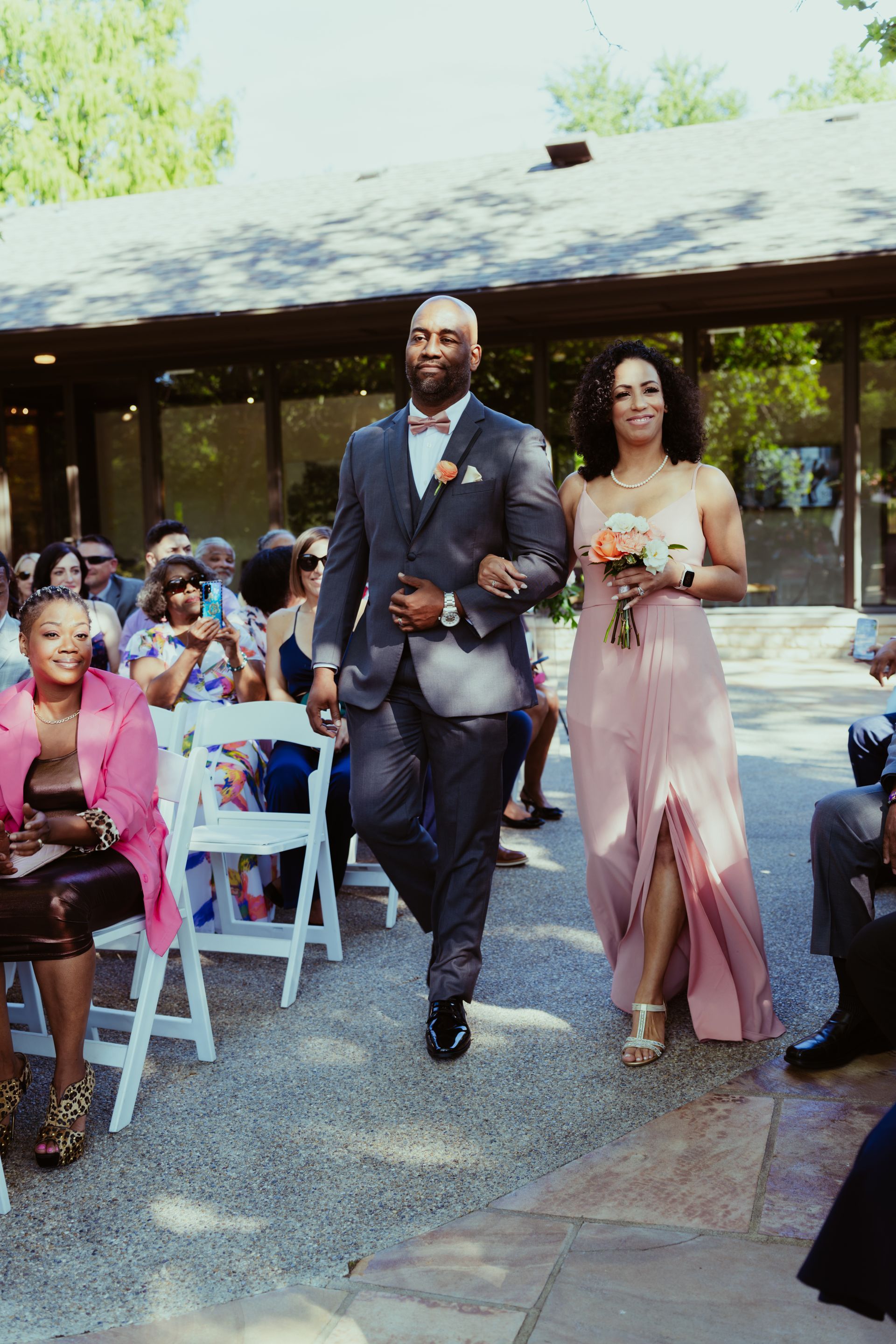 A bride and groom are walking down the aisle at a wedding.