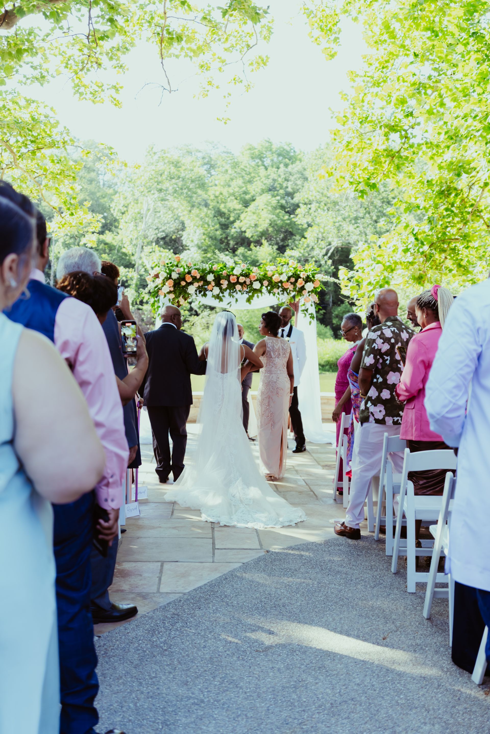 A bride and groom are walking down the aisle at a wedding ceremony.