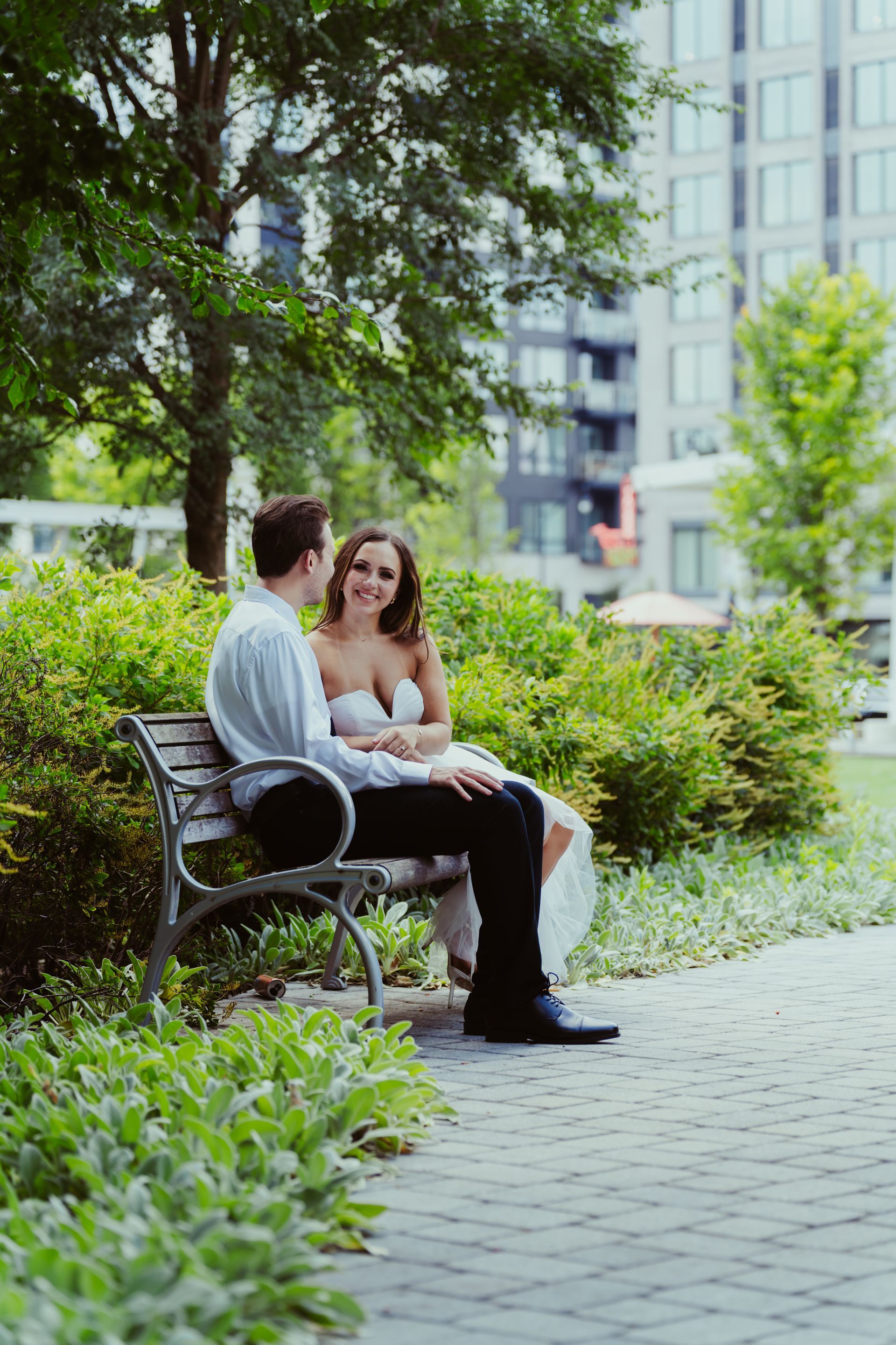 A man and a woman are sitting on a park bench.