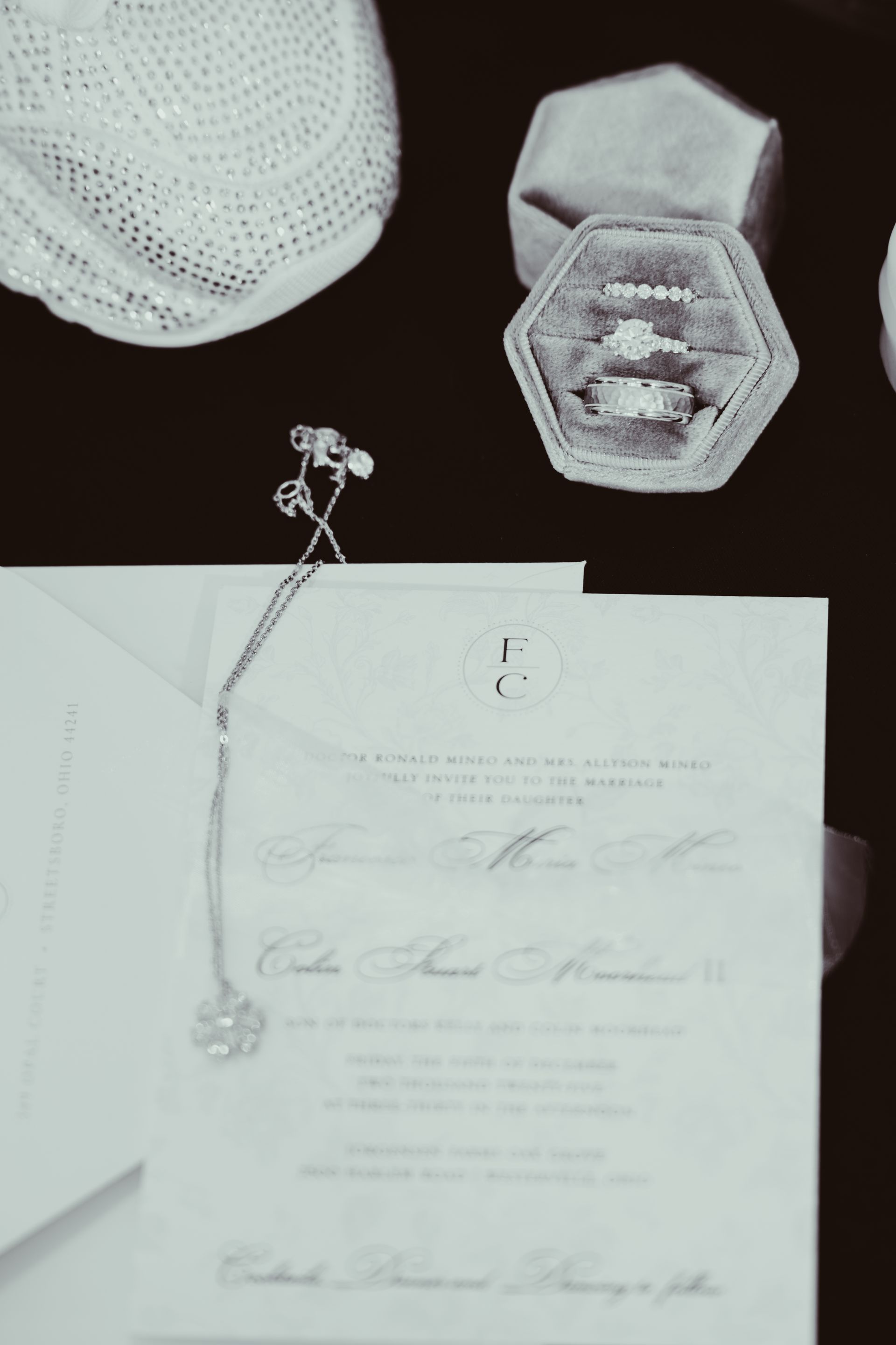 Wedding invitation with rings in a velvet box and diamond necklace.