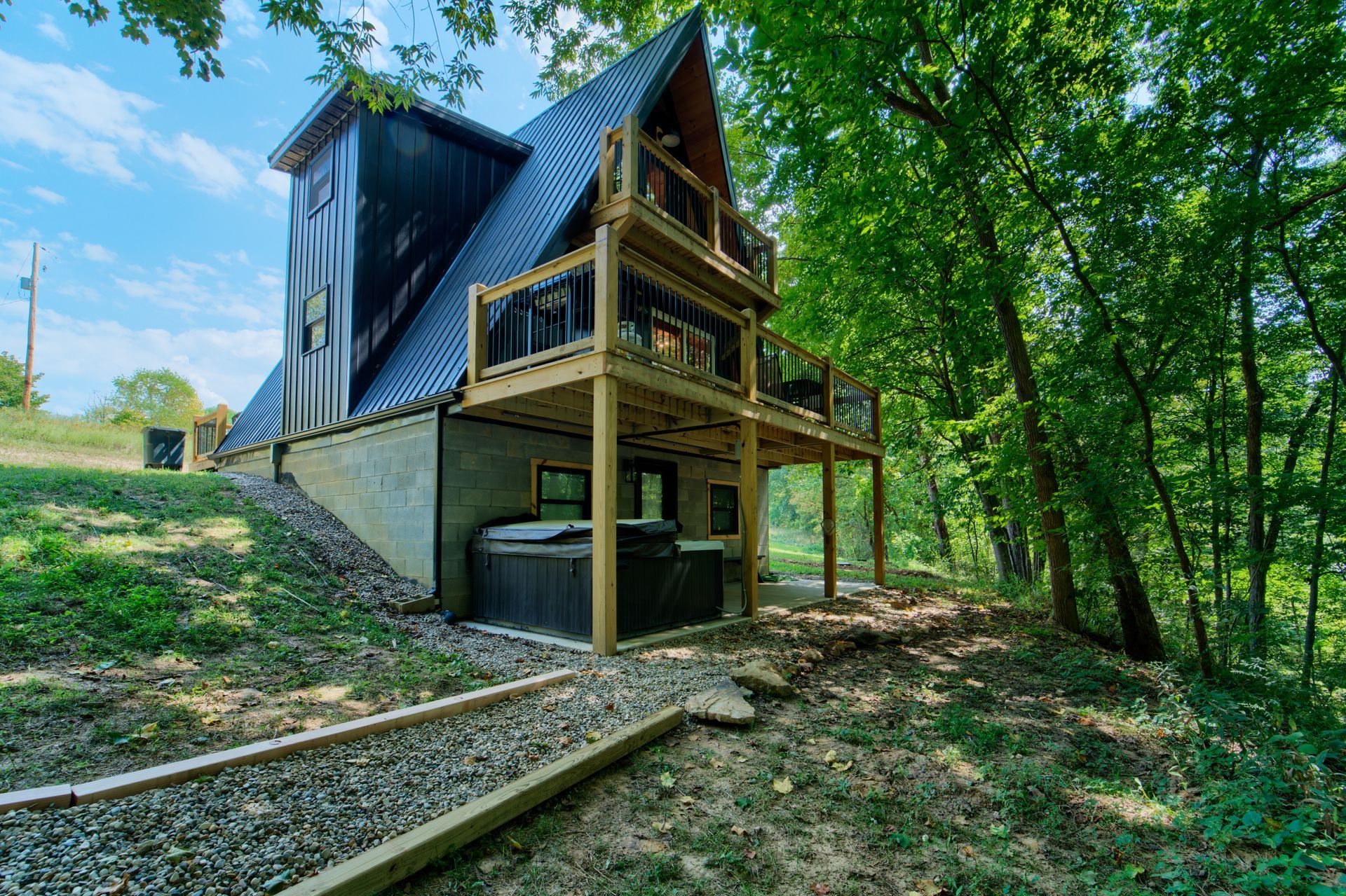 A cabin with a hot tub in the woods.