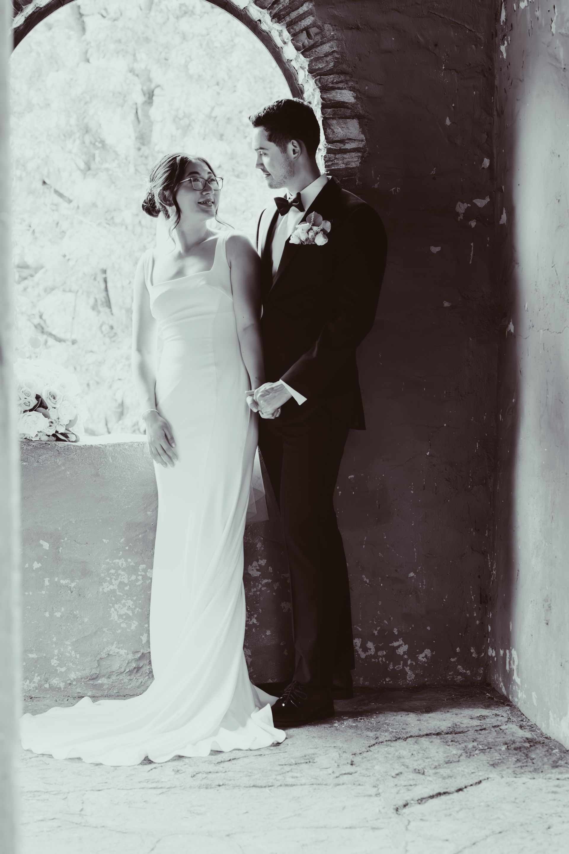 Couple kissing under falling confetti. Nighttime. Silhouette in black and white.