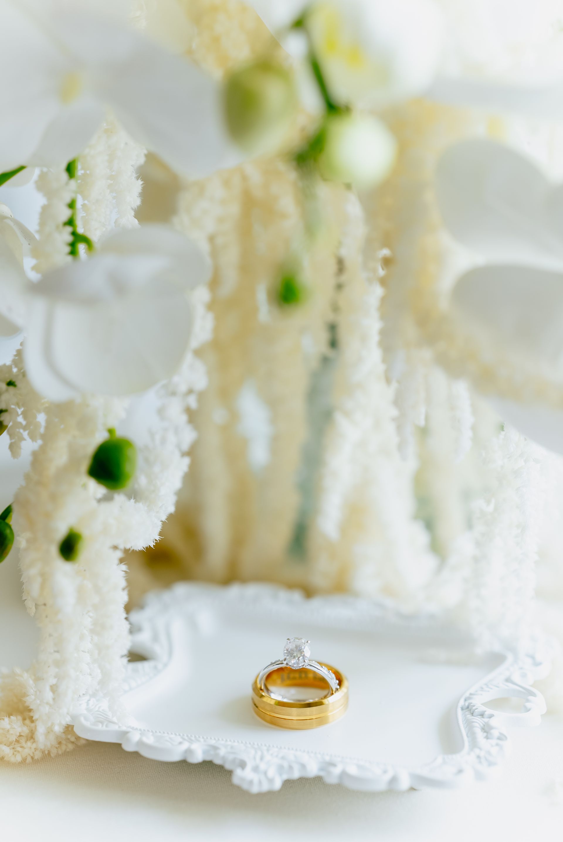 A couple of wedding rings sitting on top of a white plate.
