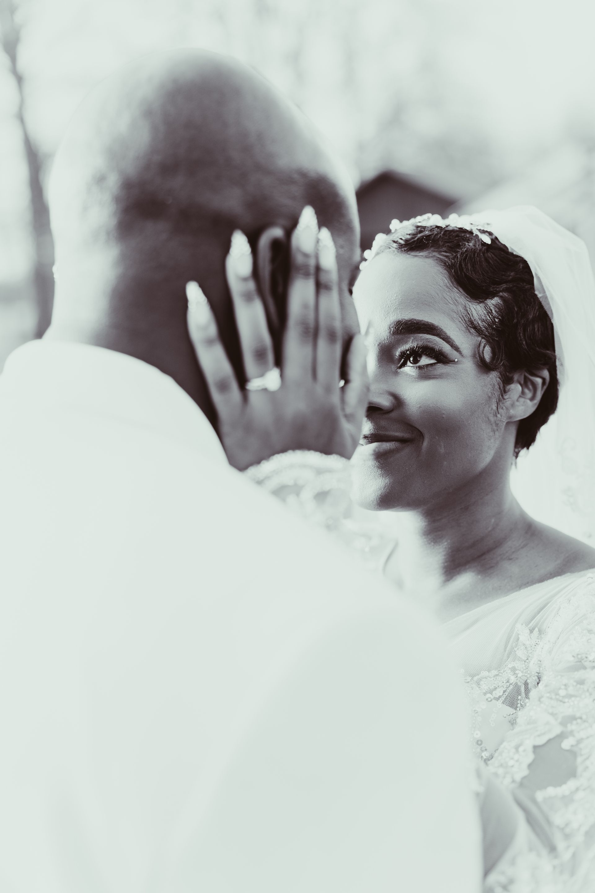 A black and white photo of a bride and groom . the bride is wearing a wedding ring.