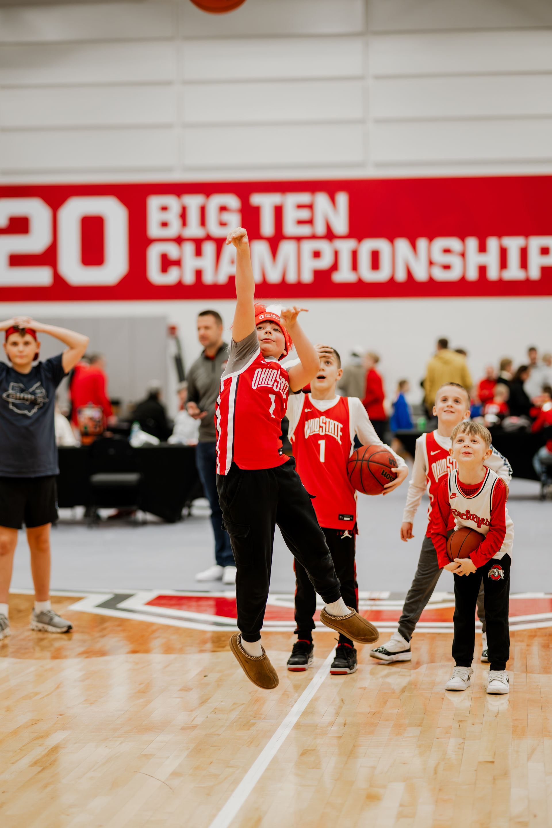 Children playing basketball on a court. .Midwest Cards | Event Photography