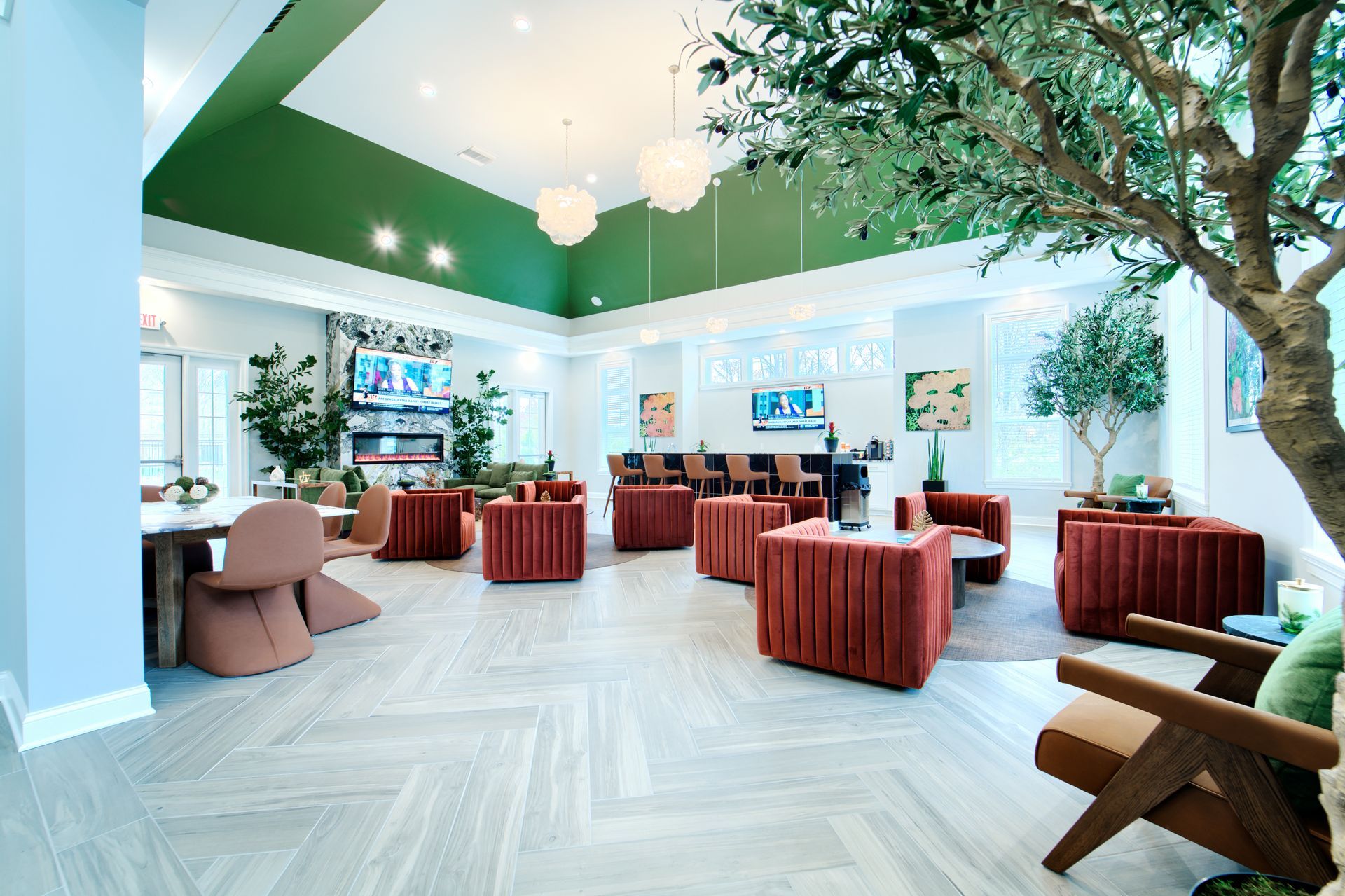 A large living room filled with furniture and a tree.