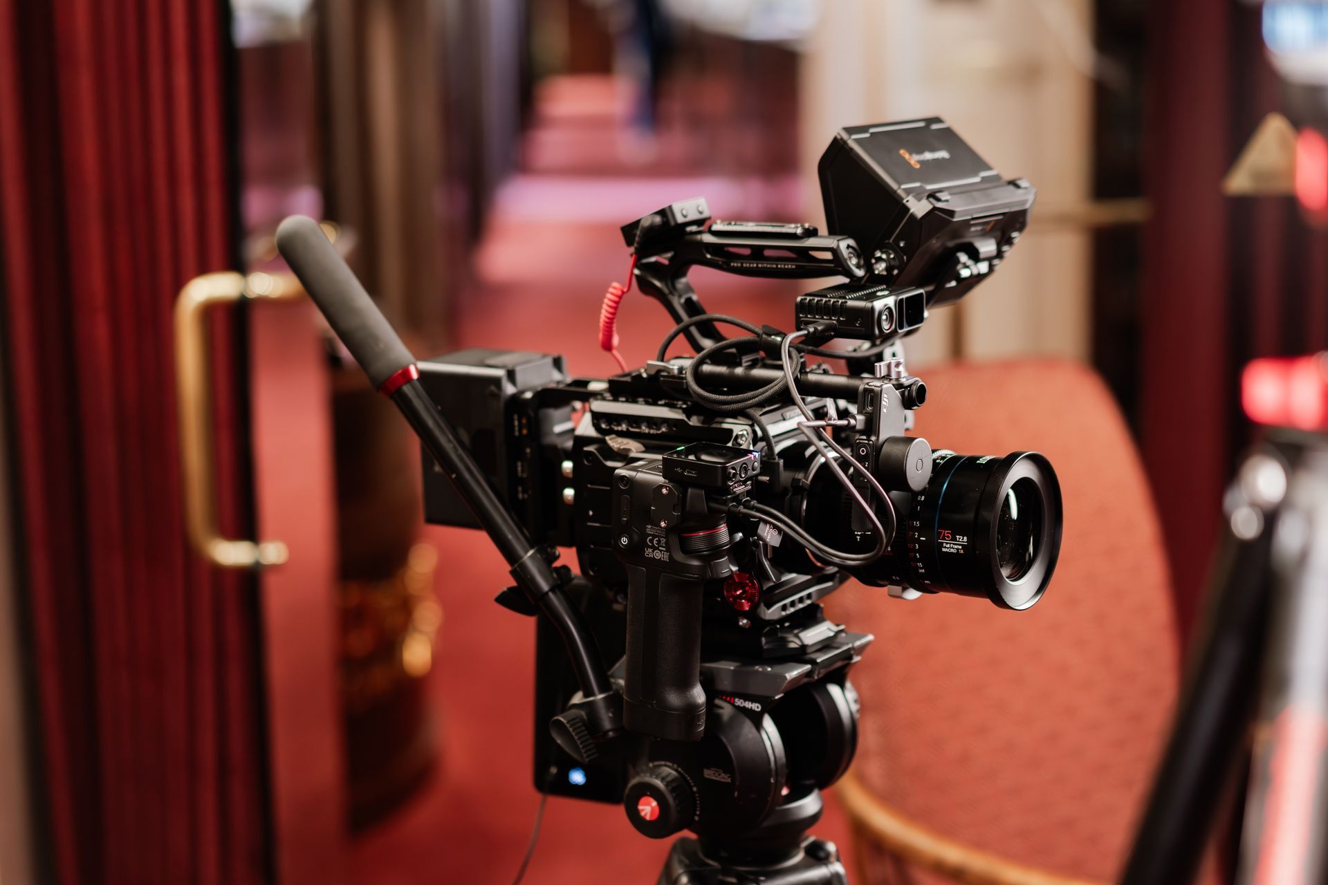 A black magic camera is sitting on top of a box