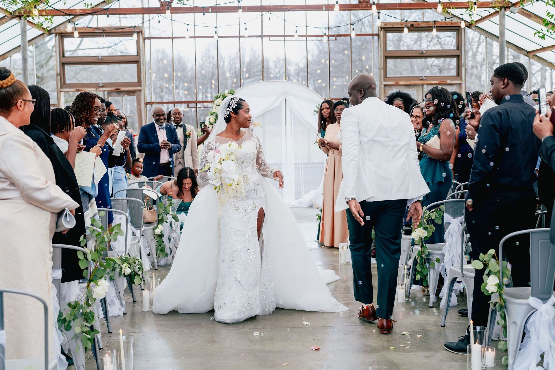 A bride and groom are walking down the aisle at their wedding.