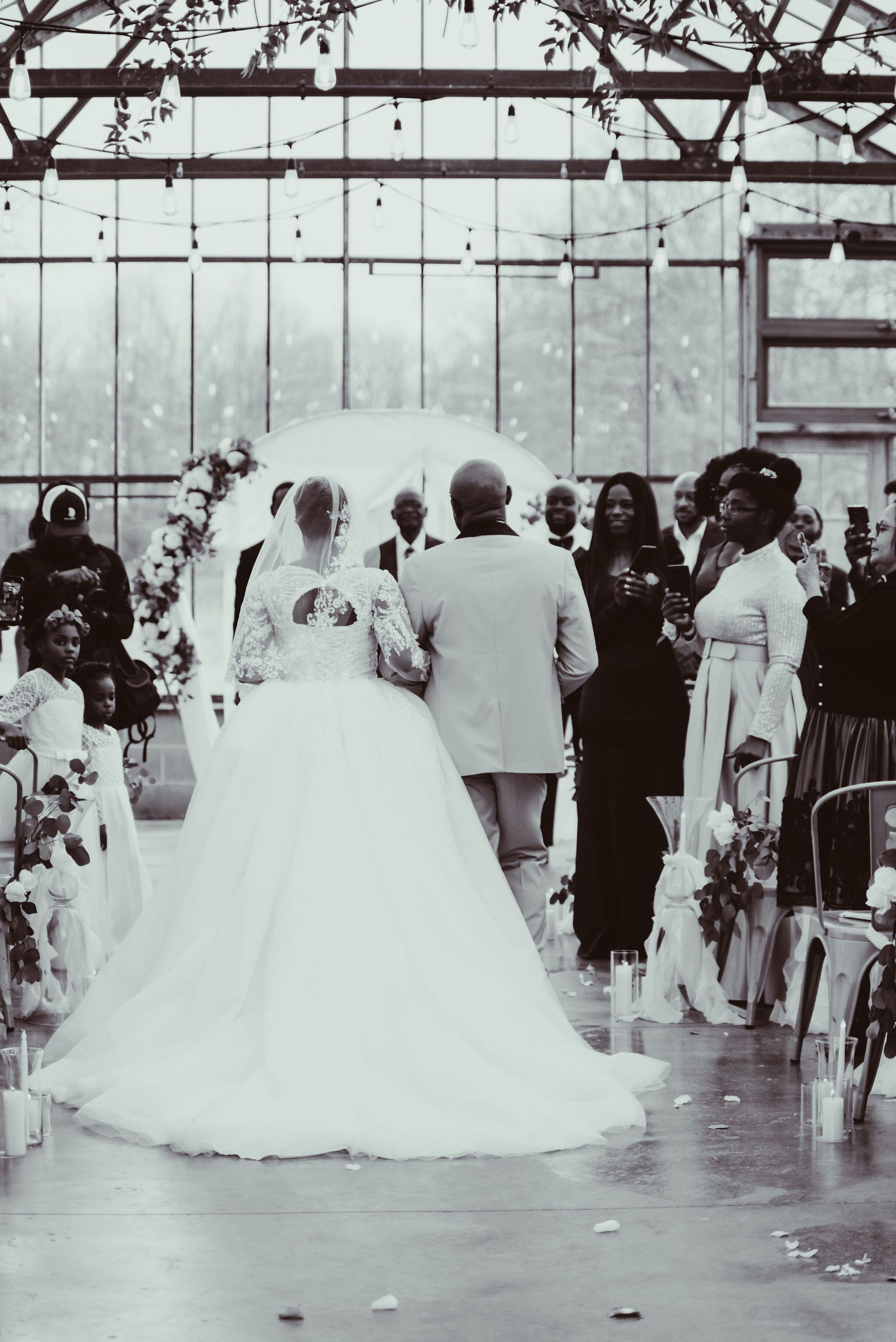 A bride and groom are walking down the aisle at their wedding.