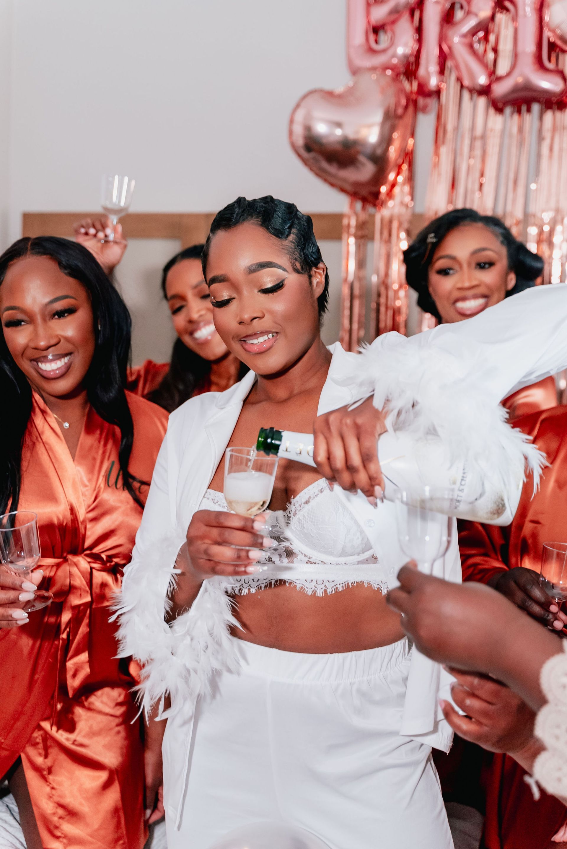 A woman is pouring champagne into a glass at a bridal shower.