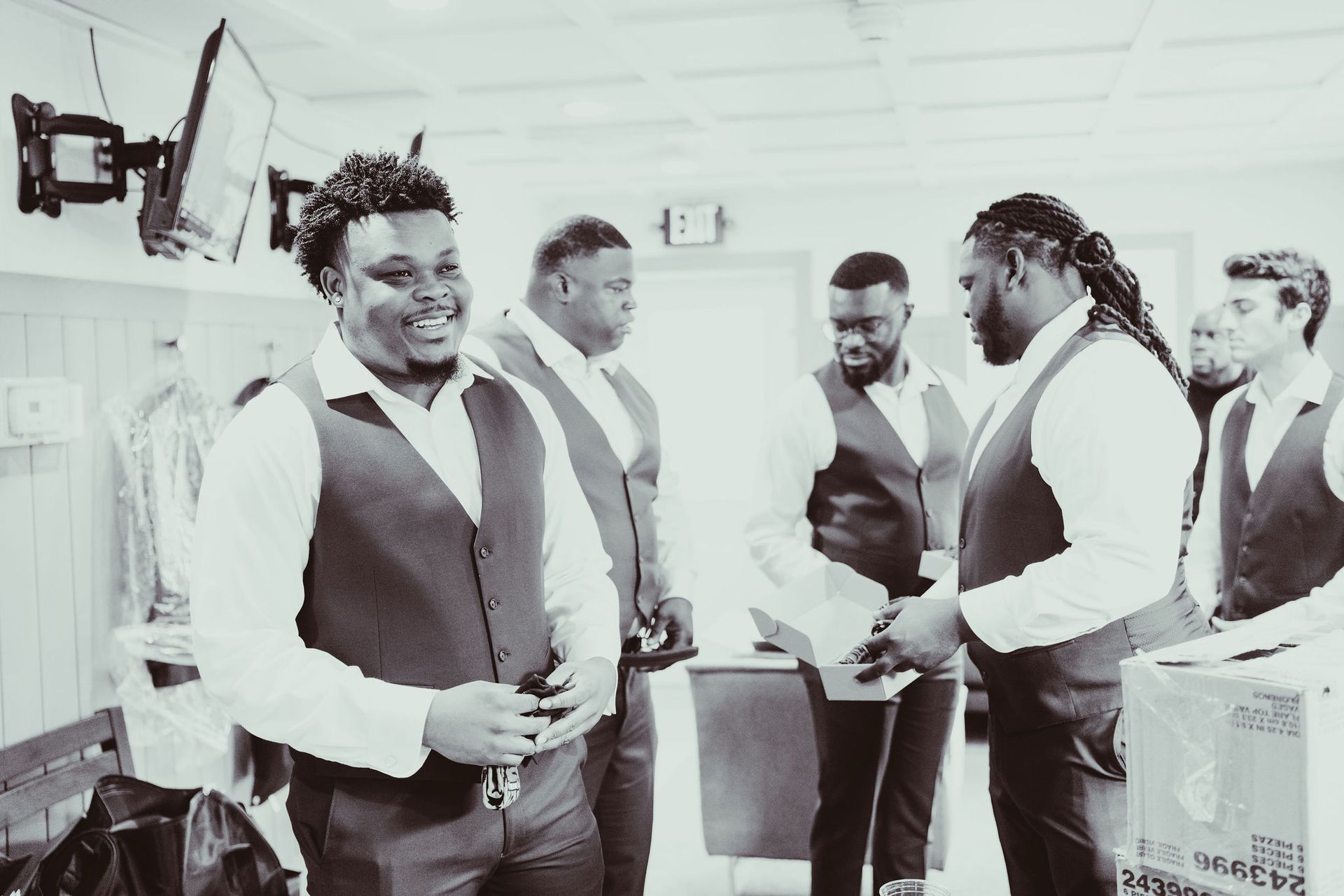 A group of men are standing next to each other in a room.