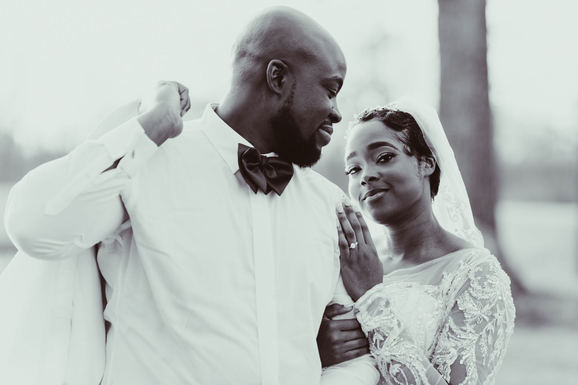 A black and white photo of a bride and groom looking at each other.