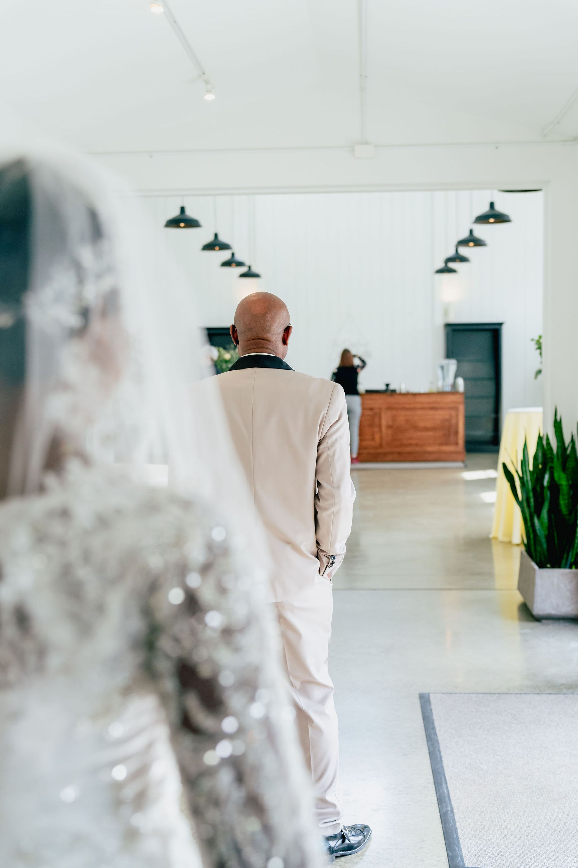A man in a suit is walking towards a woman in a wedding dress.