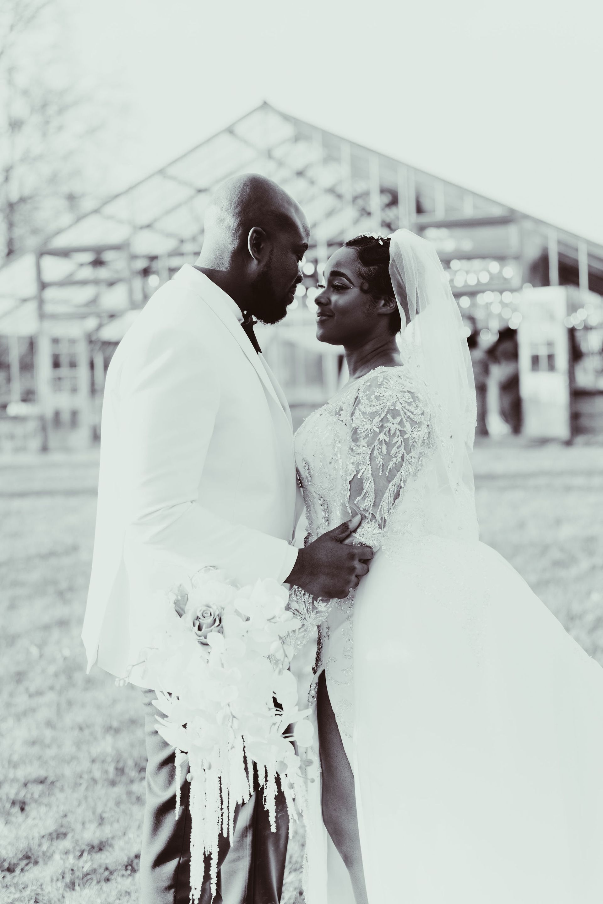 A black and white photo of a bride and groom looking at each other.