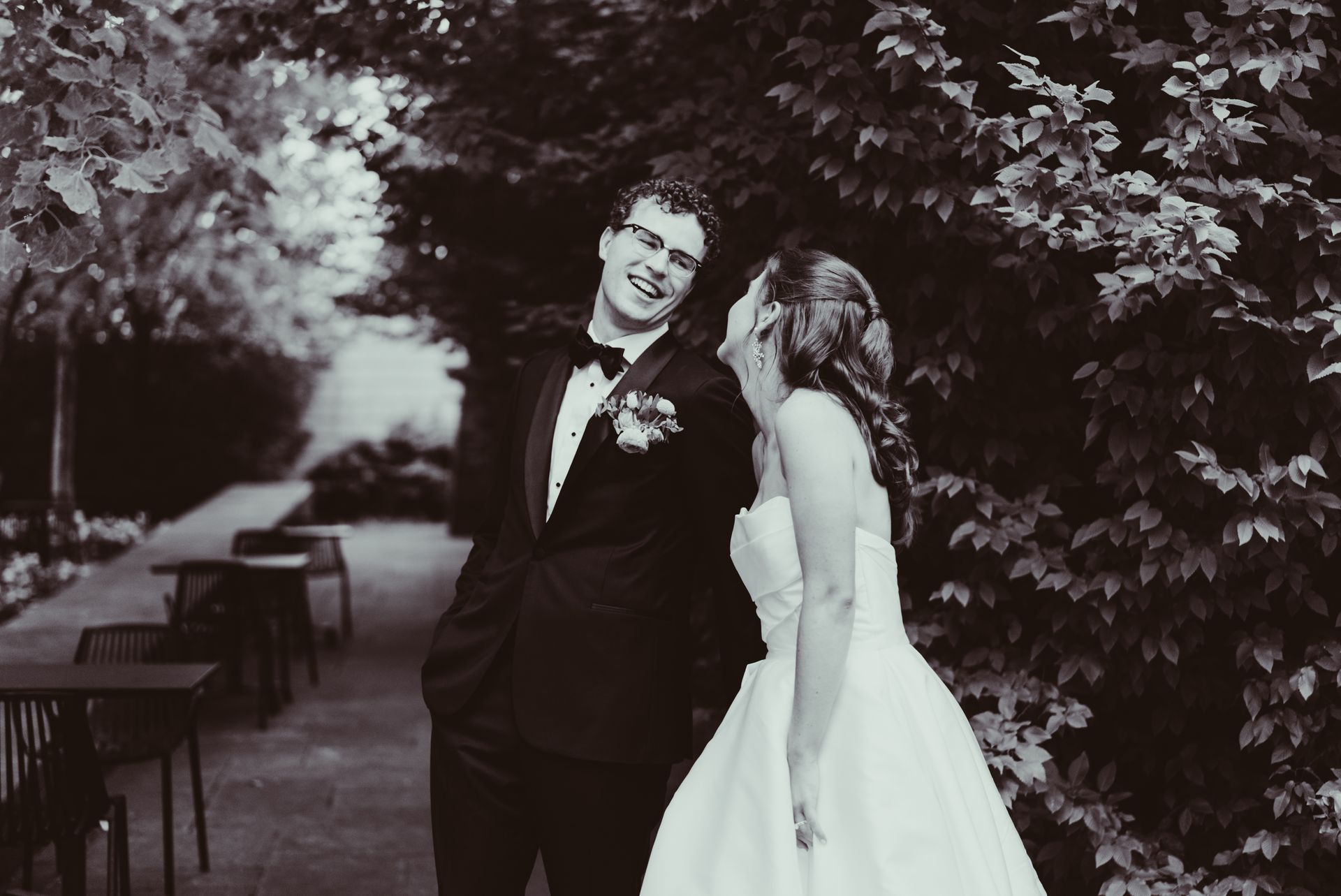 A black and white photo of a bride and groom standing next to each other.