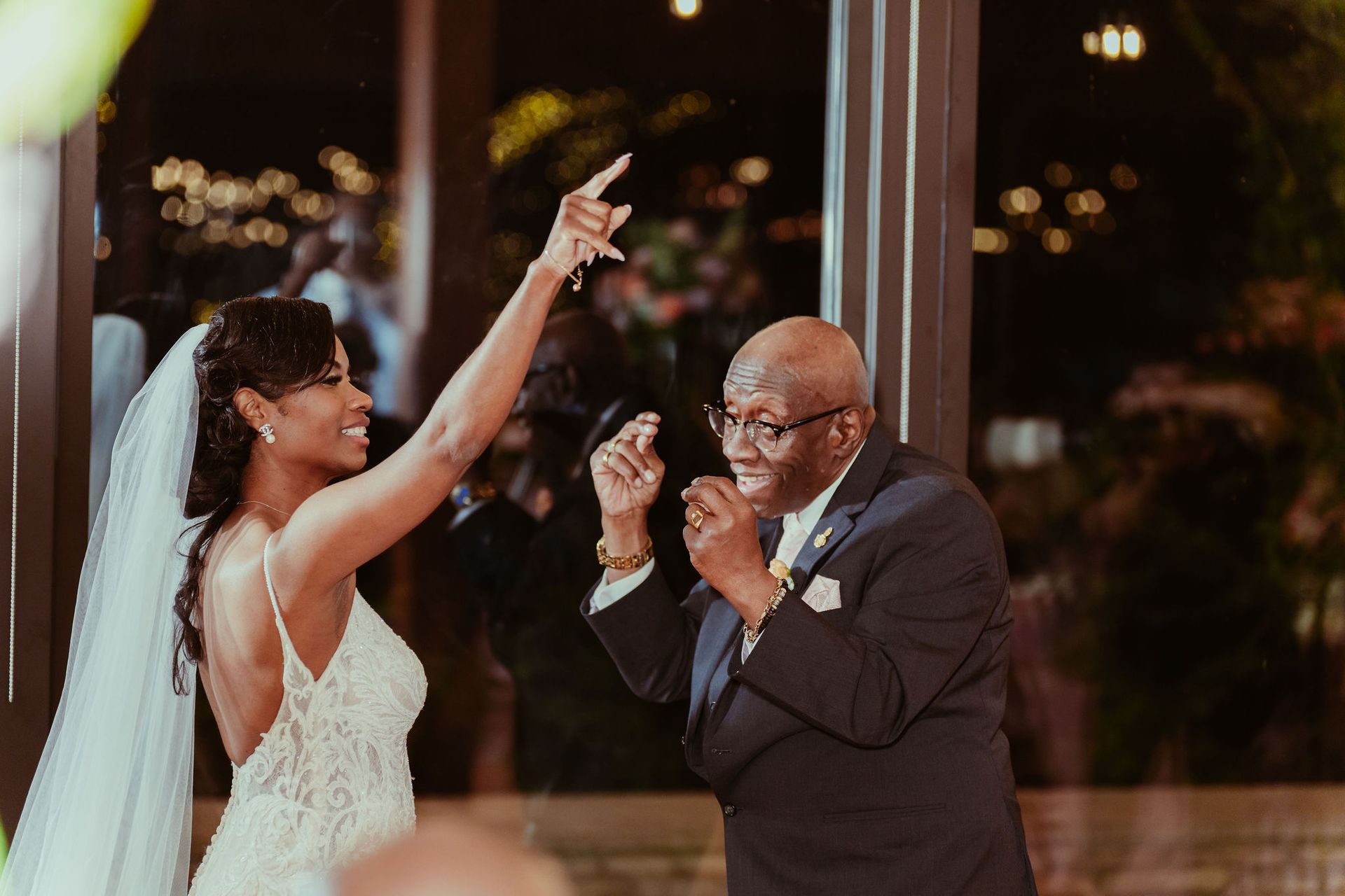 A bride and her father are dancing at a wedding reception.