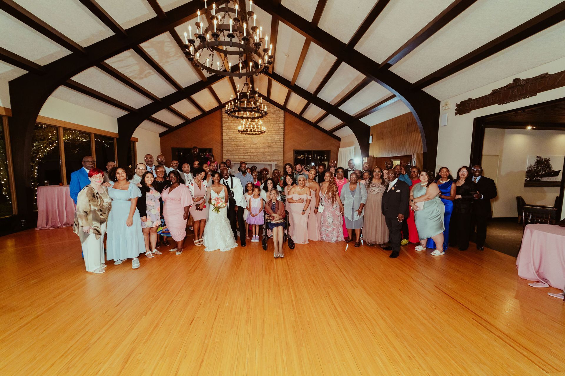 A large group of people are posing for a picture in a large room.