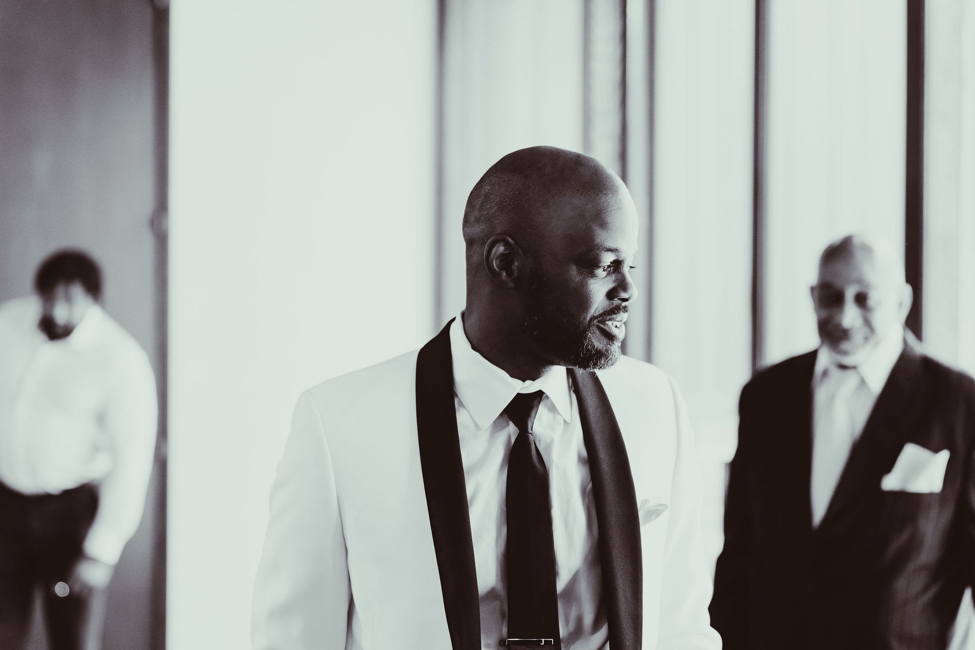 A black and white photo of a man in a tuxedo