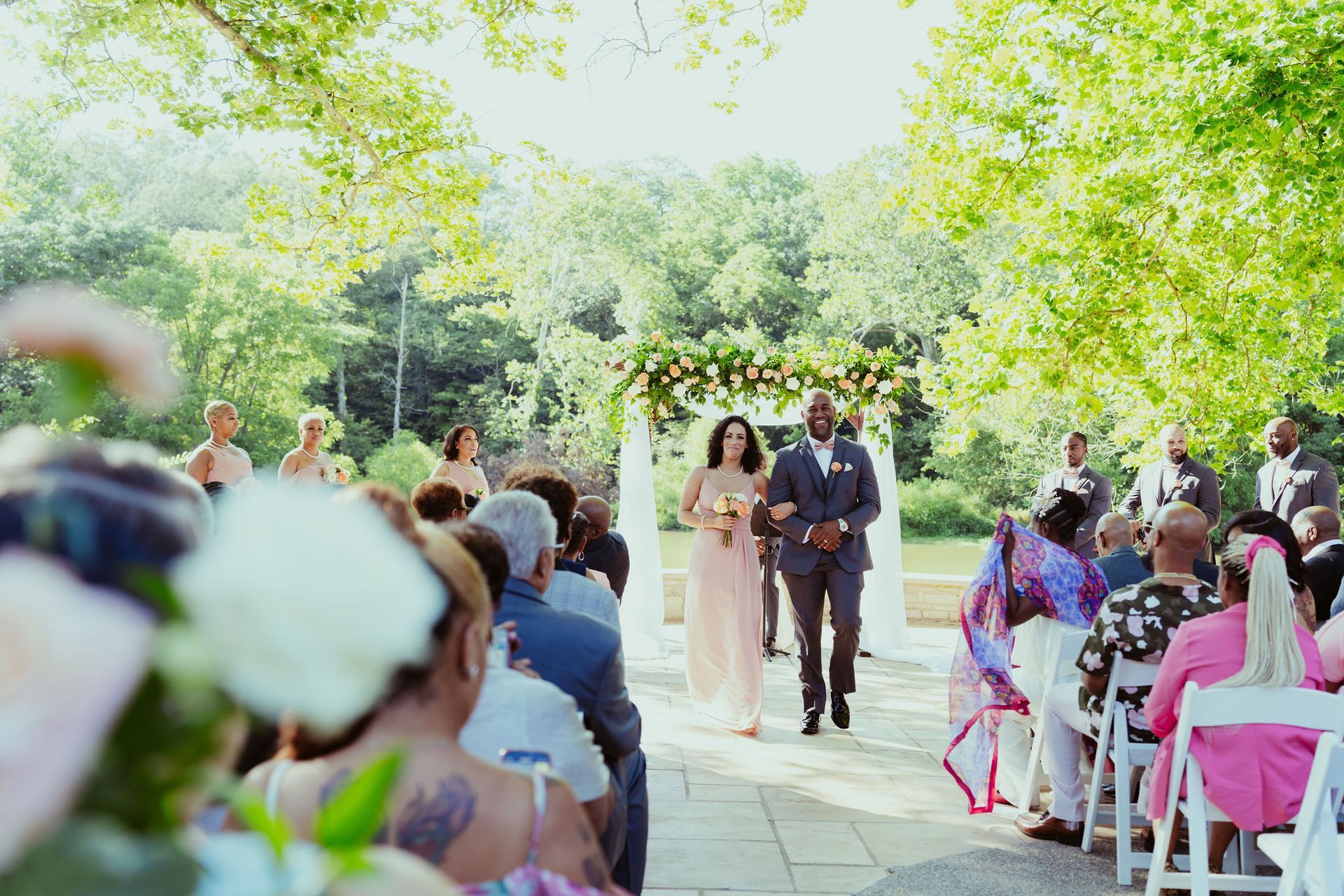 A bride and groom are walking down the aisle at a wedding ceremony.