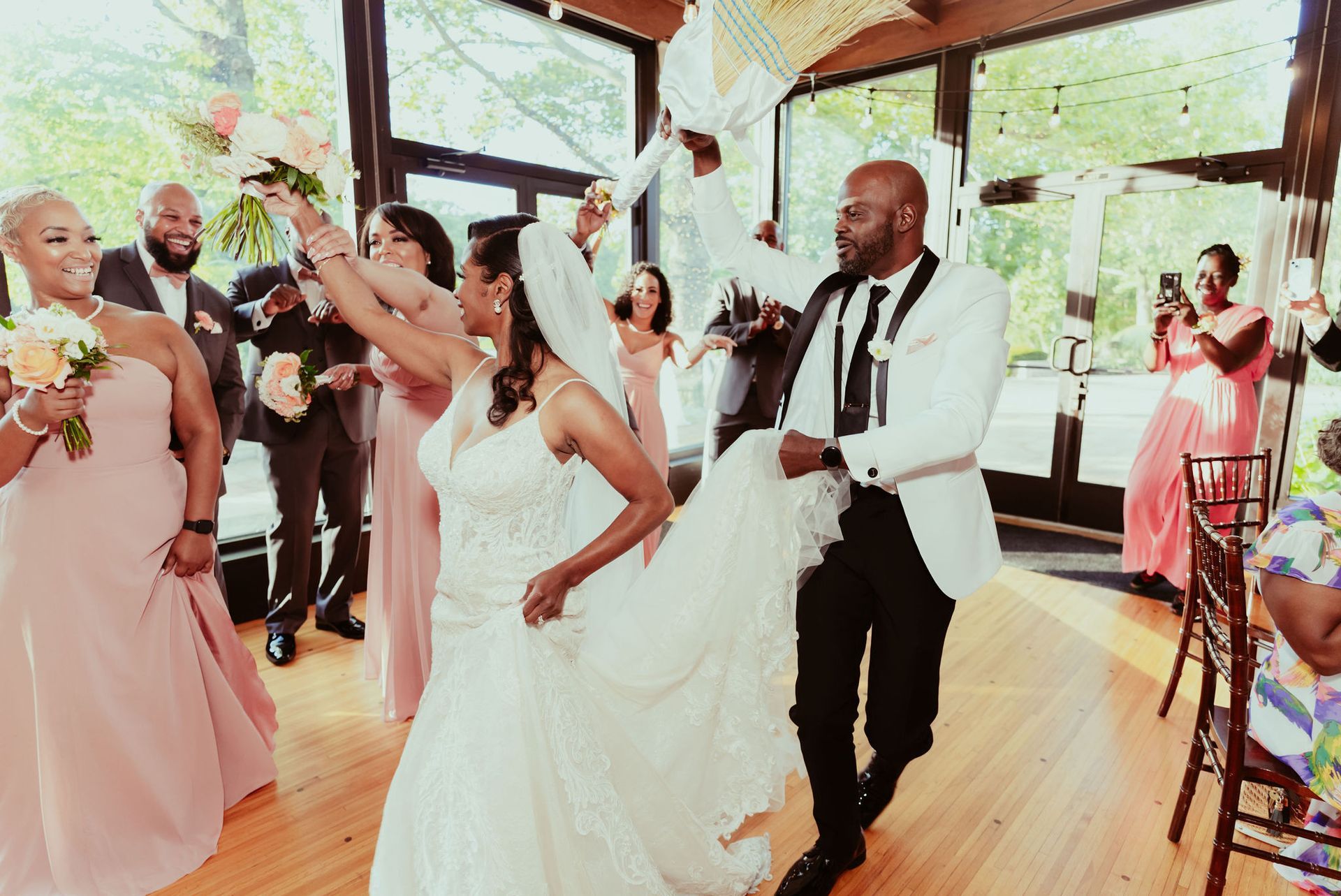 A bride and groom are dancing with their wedding party at their wedding reception.