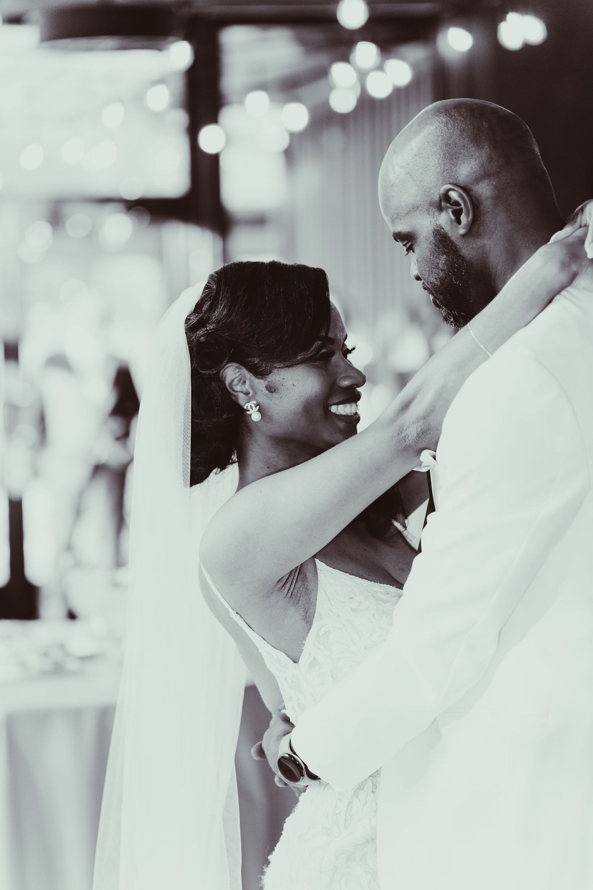 A black and white photo of a bride and groom dancing