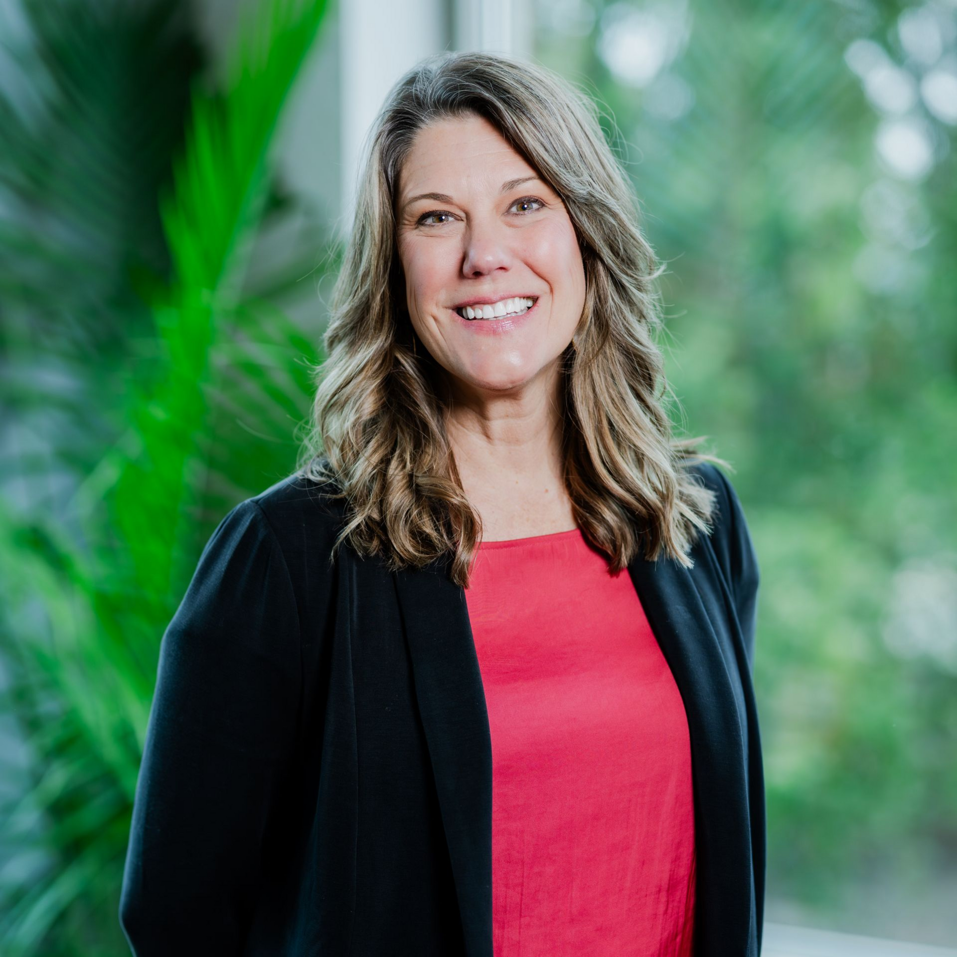 A woman in a white lab coat is sitting on a yellow chair.