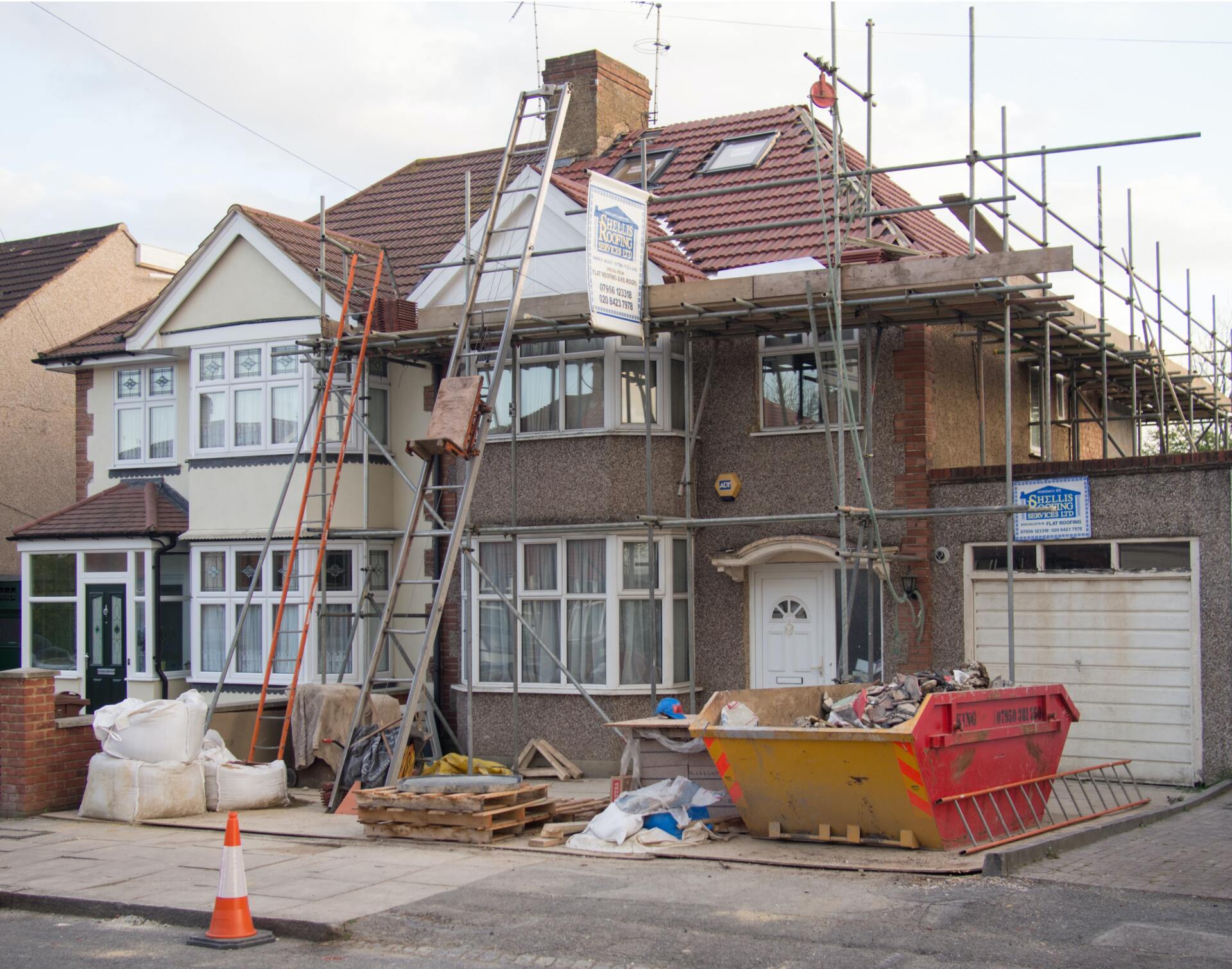 A house is being remodeled with scaffolding around it