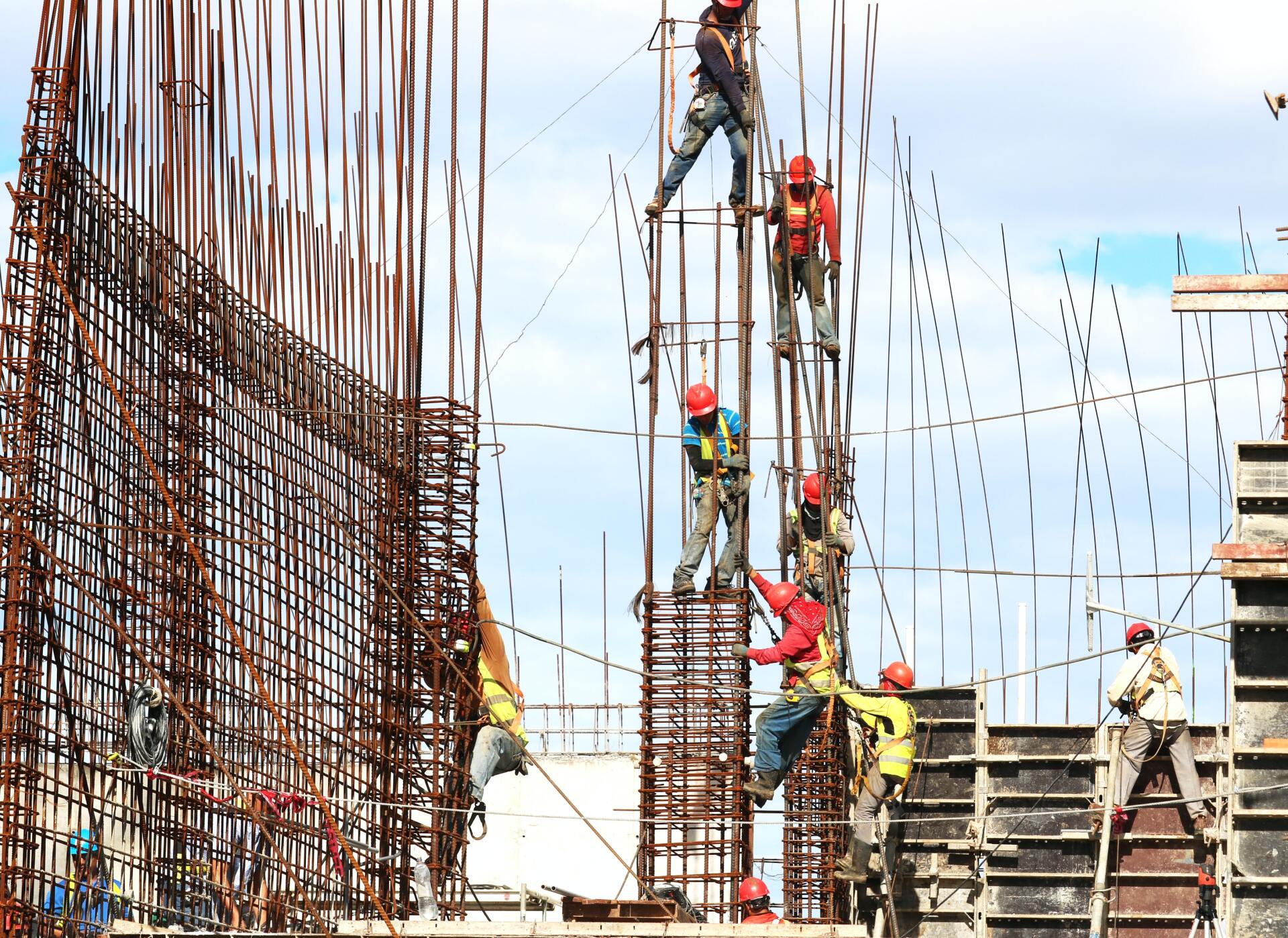 A group of construction workers are working on a building under construction.