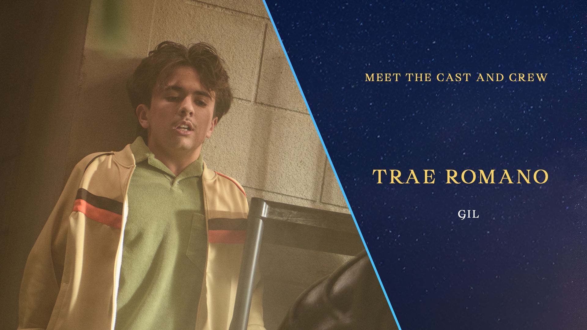 A man standing next to a wall with the name trae romano on the bottom