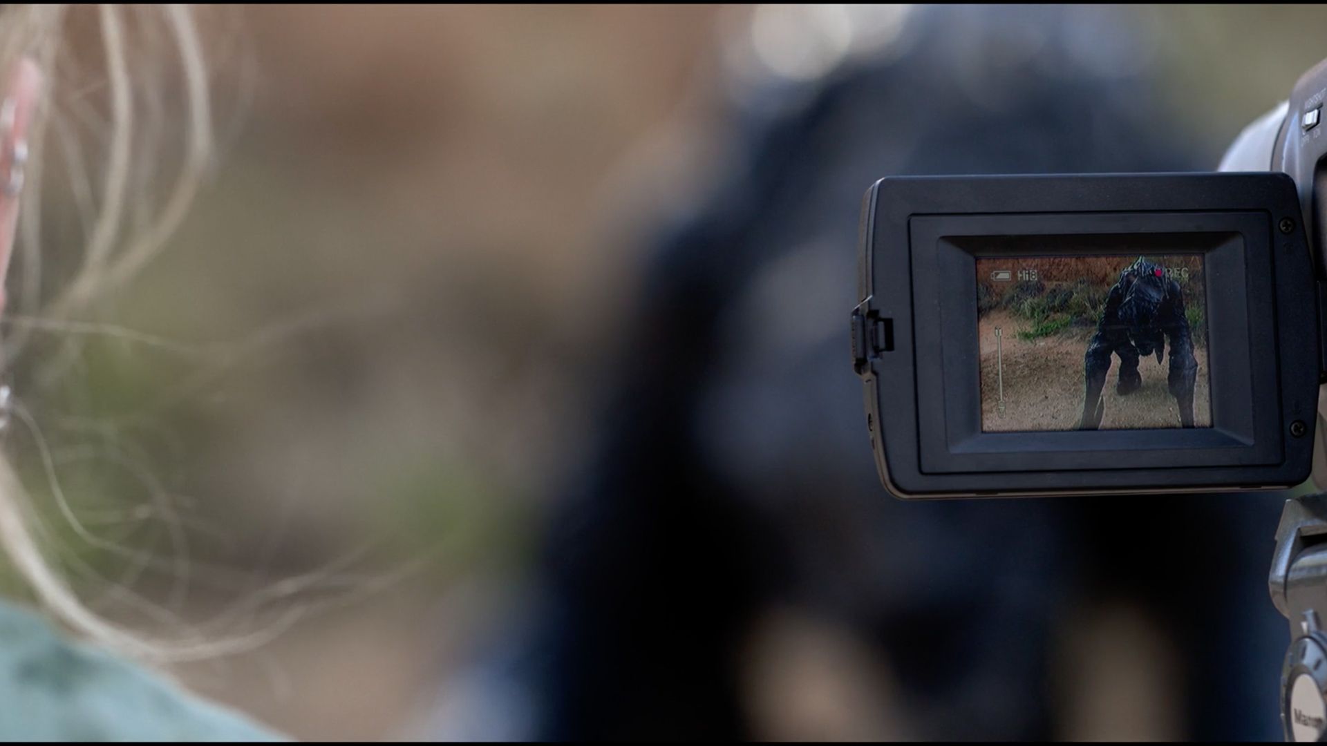 A person is taking a picture of a dog with a camera.