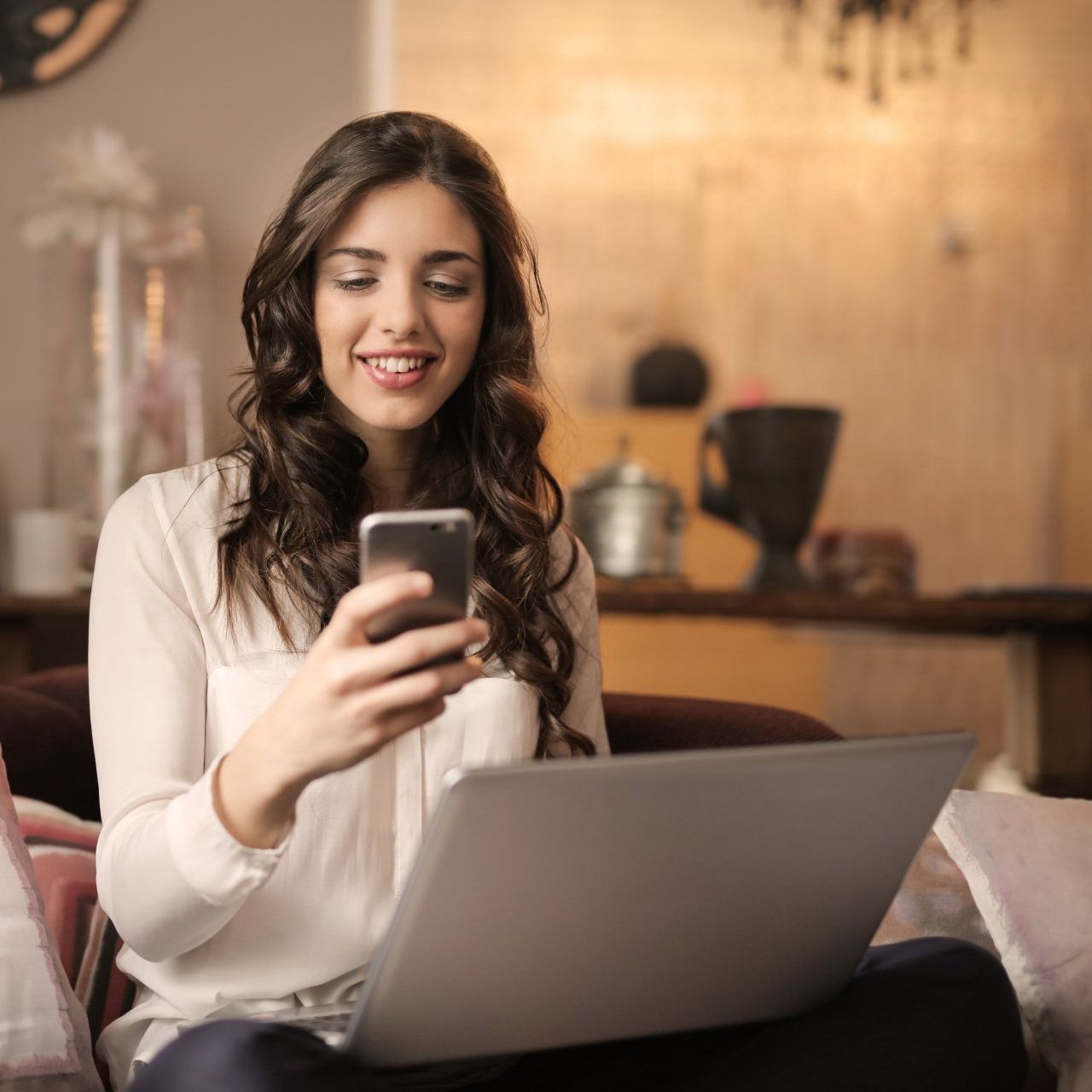 Woman smiles while looking at her phone tax service app.