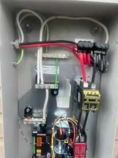 The inside of an electrical box with a lot of wires coming out of it.