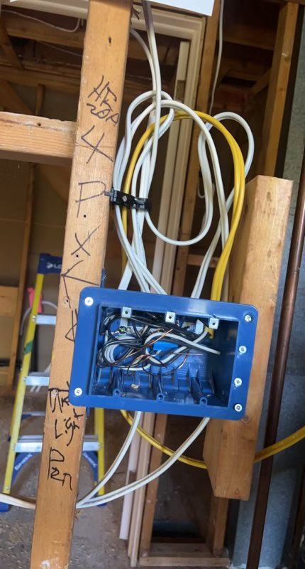 A blue box with a bunch of wires hanging out of it