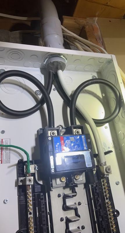 A close up of an electrical box with wires coming out of it.